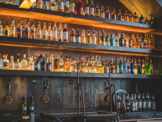 Liquor on bar shelf with beer taps underneath